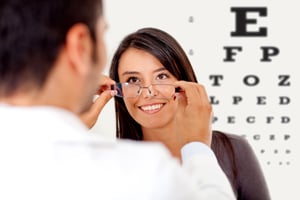 Woman wearing glasses after taking a vision test at the doctor